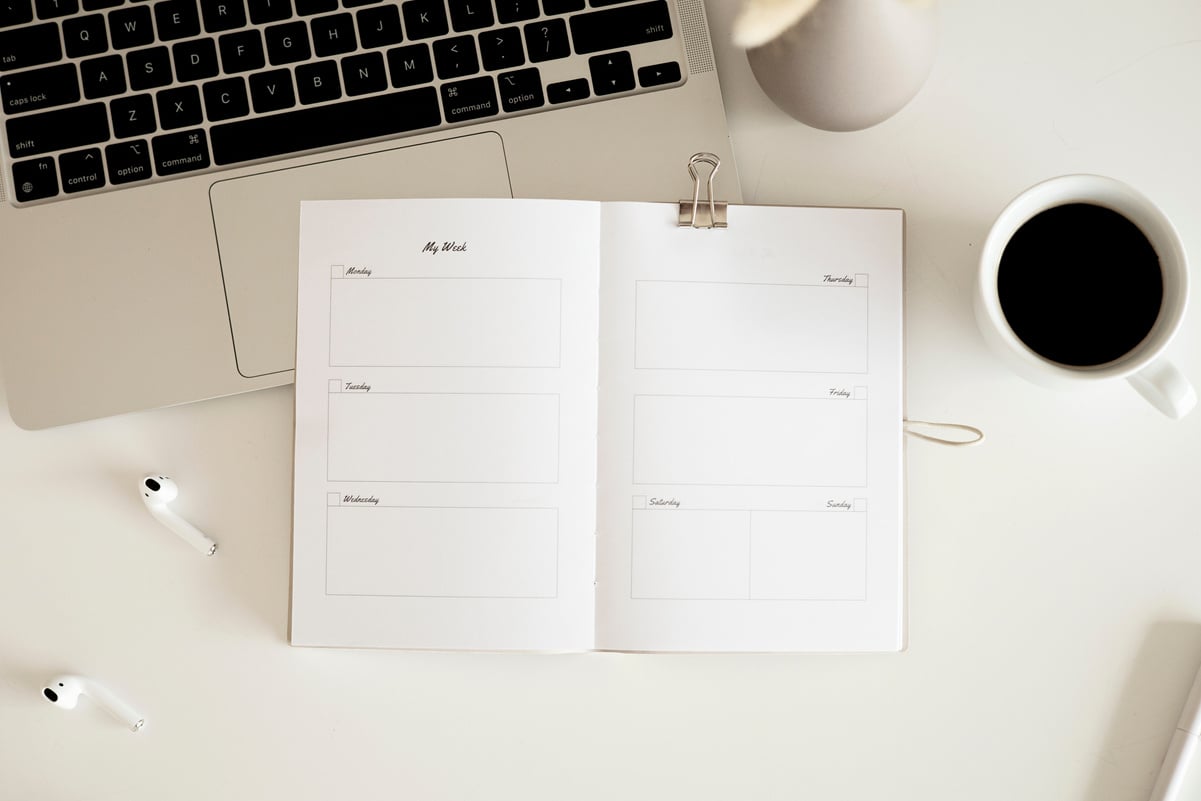 An Open Notebook Planner on White Surface 